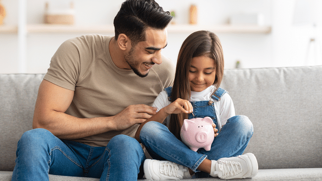 Father and Daughter with Piggy Bank